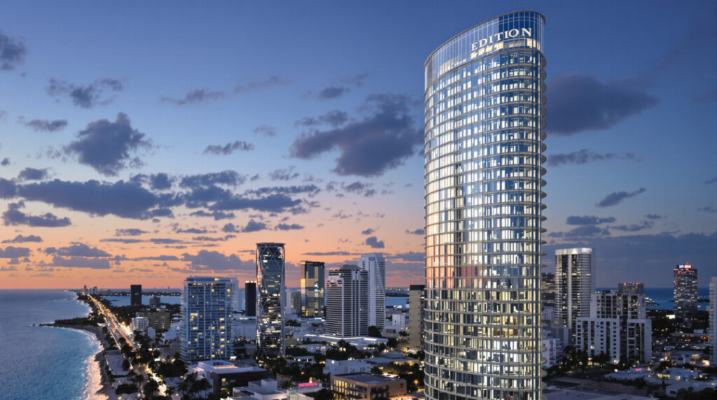 A stunning architectural rendering of the EDITION Residences glass tower against the Miami skyline at dusk