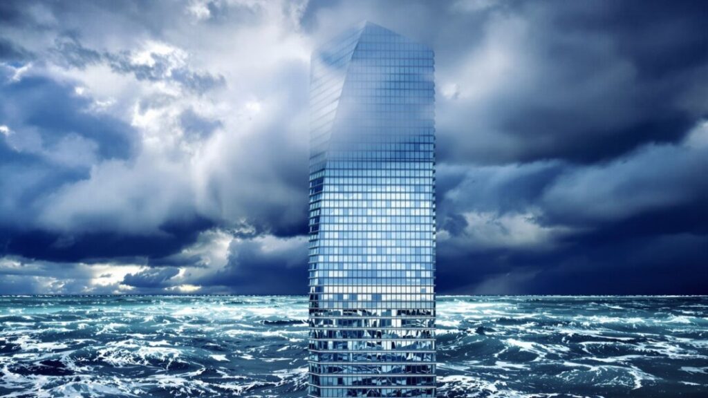 Skyscraper against stormy sky and turbulent ocean.