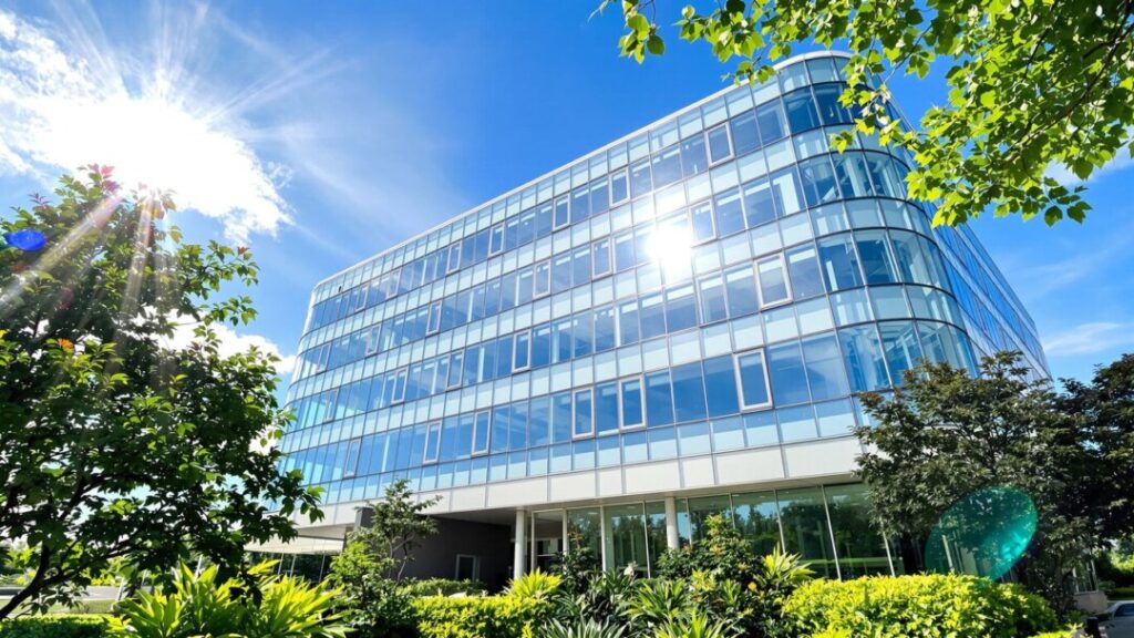 Modern office building under a clear blue sky.
