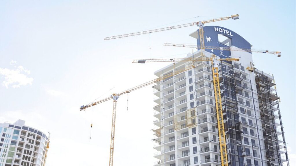 Modern hotel construction against a bright sky.