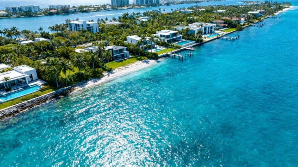 Miami skyline with luxury waterfront properties and ocean.