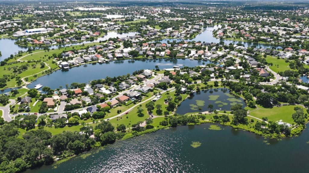 Aerial view of Indian Creek homes and green spaces near water.