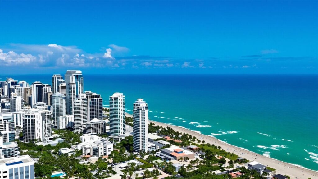 Miami-Dade coastline with high-rise buildings and palm trees.