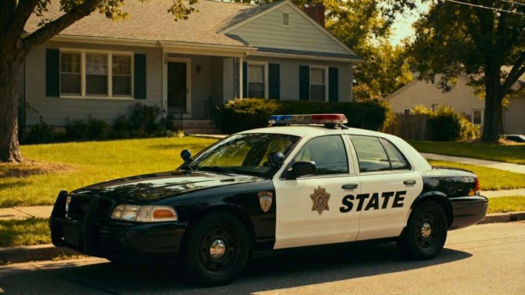 Patrol car parked in a suburban neighborhood.