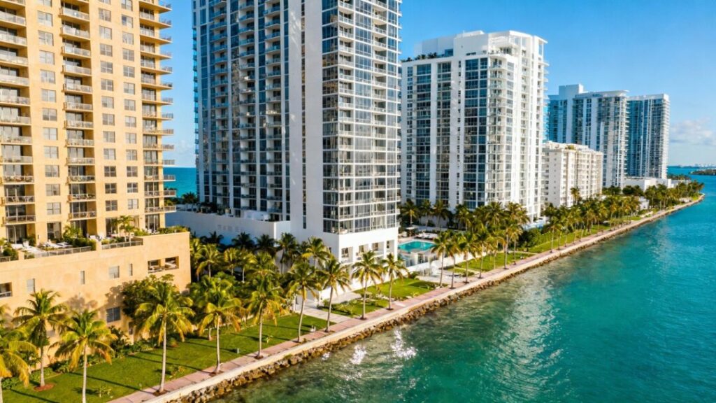 Luxury Miami condos with palm trees and waterfront view