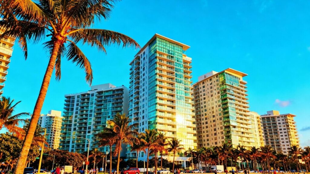 Miami skyline with modern apartment buildings and palm trees.