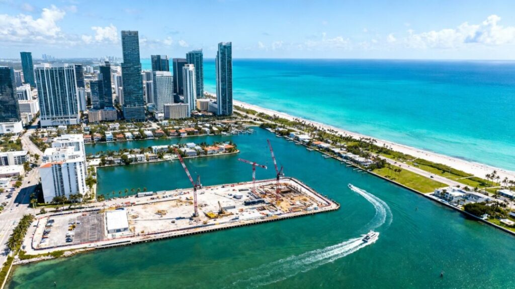 Brickell waterfront parcel with cranes and city skyline.