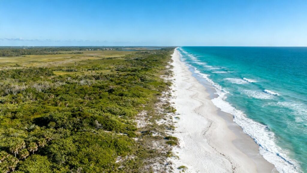 Florida oceanfront land with turquoise water and sandy beach.