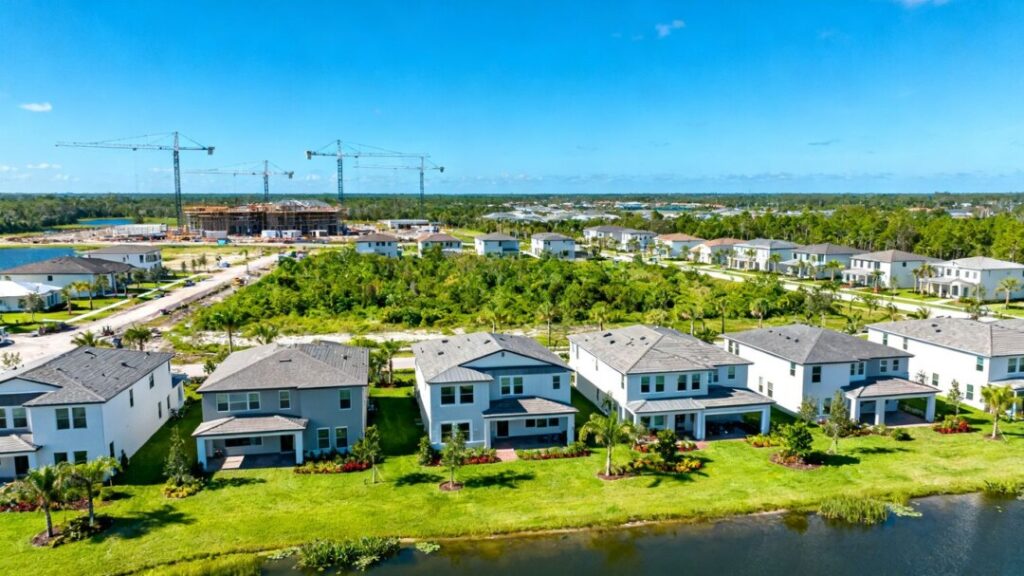 Florida housing development with cranes and new homes.