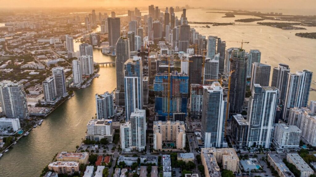Brickell condo towers crowd the waterfront beneath construction cranes.