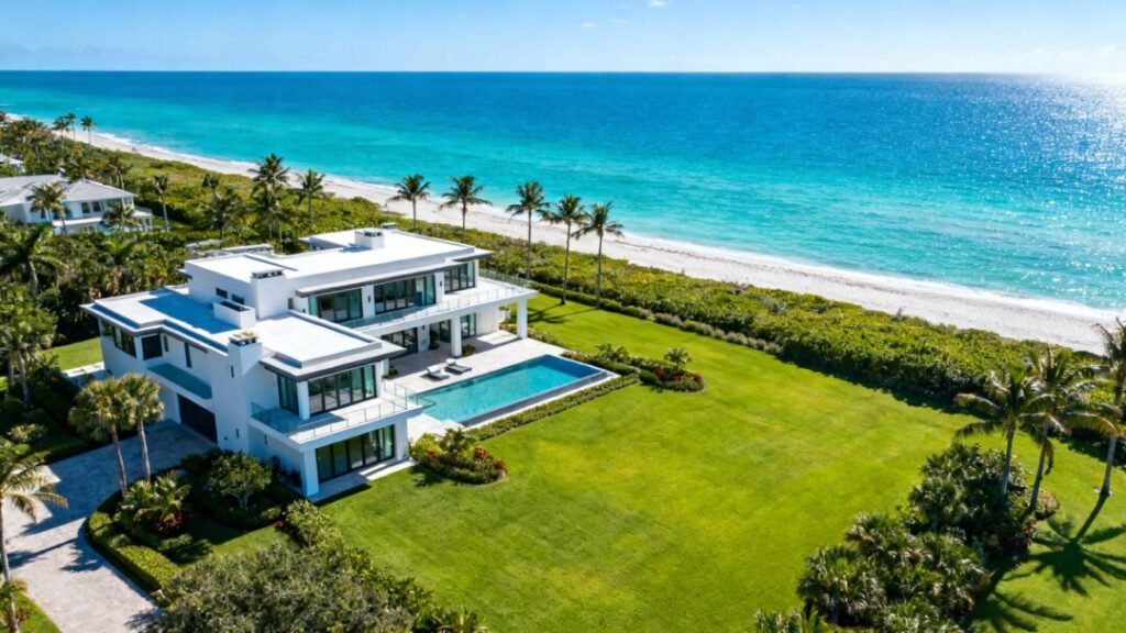 Oceanfront estate with mansion, lawns, and private beach.